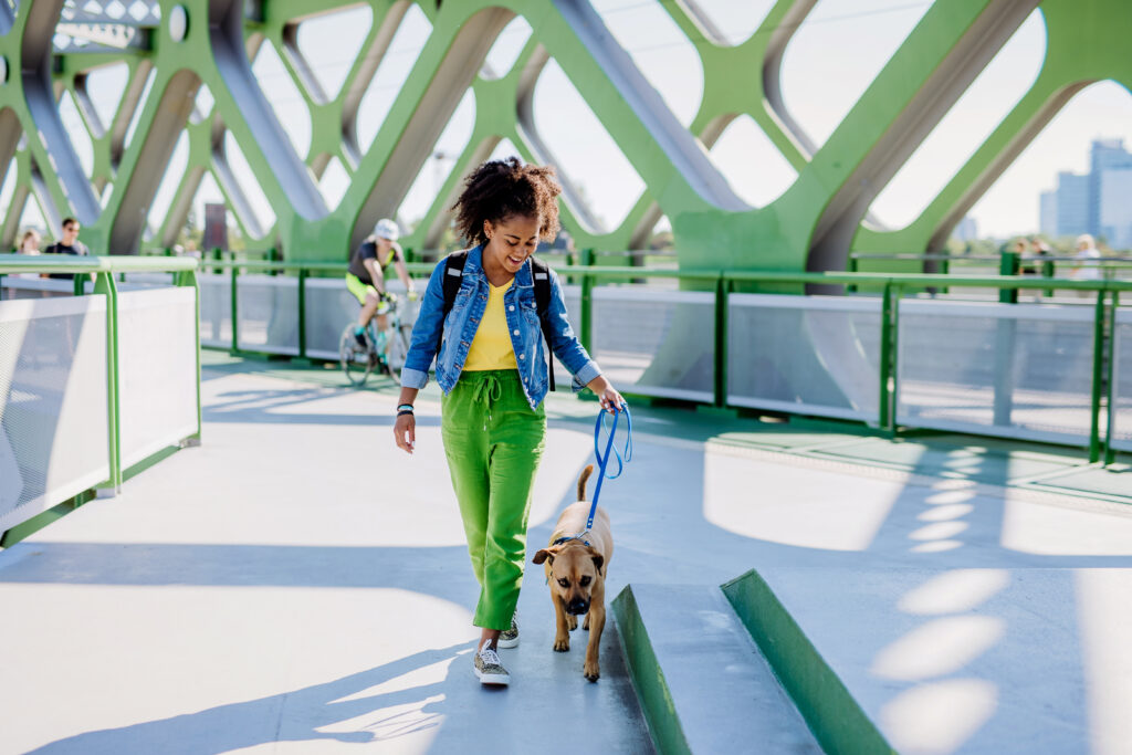 Girl walking with her dog outside 