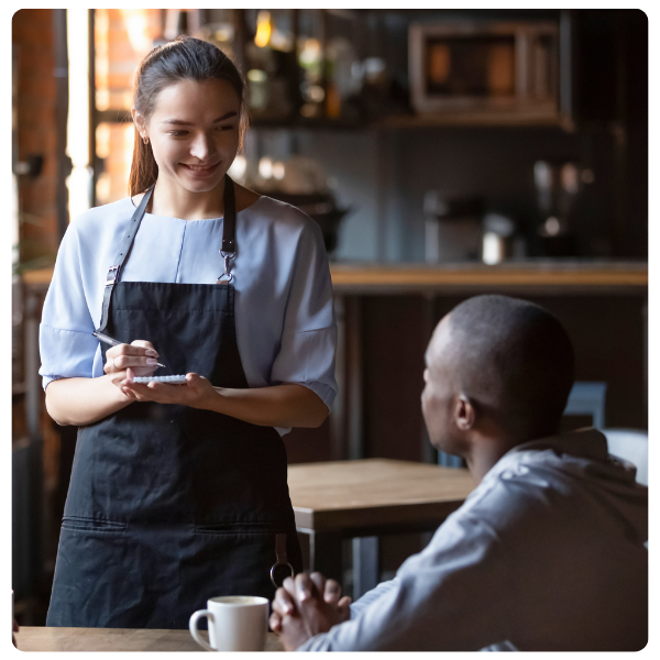 woman waitress taking a male guest's order at restaurant
